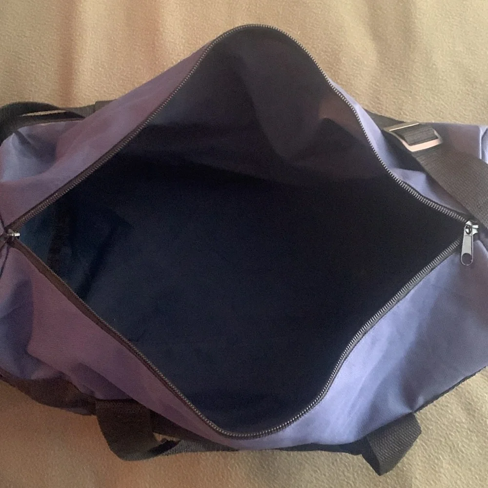 Smithsonian Air & Space blue and black duffel bag. Approx 17” x 9” x 7 1/4”